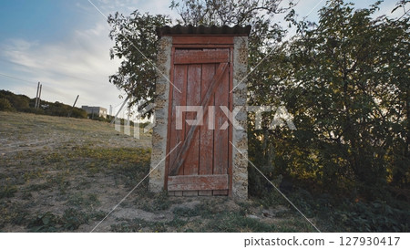 Village restroom in the evening at sunset. 127930417