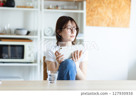 A woman watching a tablet A woman watching a tablet 127930938