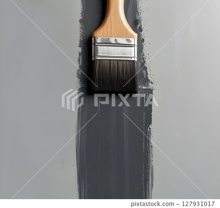 Gray paint stripe applying on wall, showcasing home renovation process with precise brushwork. Creative interior transformation happening through careful painting technique 127931017