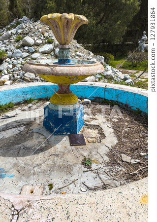 Weathered stone fountain in neglected park area in Kyrgyzstan Weathered stone fountain in neglected park area in Kyrgyzstan 127931864