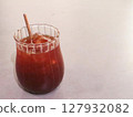 close up of a glass of iced americano with a eco friendly sugar cane straw with copy space on a white table 127932082
