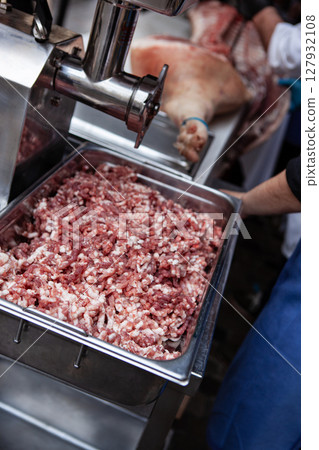 Mincer and pork meat for delicatessen 127932108