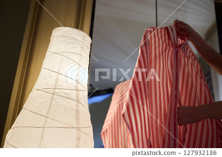 Delicate Dressing Preparing an Elegant Outfit in Soft, Cozy Lighting for Daily Wear and Style 127932186