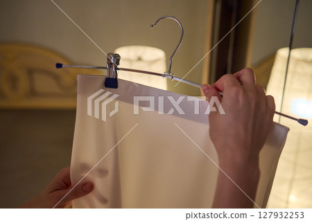 Delicate Dressing Preparing an Elegant Outfit in Soft, Cozy Lighting for Daily Wear and Style 127932253