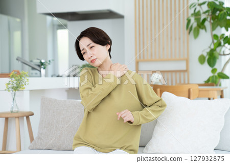 Middle-aged housewife with stiff shoulders Middle-aged housewife with stiff shoulders 127932875