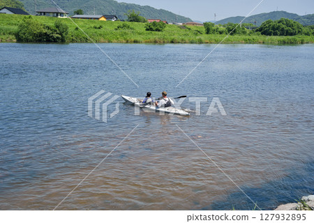Two-seater river kayak: Parent and child river fun 127932895