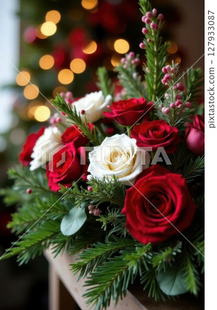 Christmas flower arrangement illuminating festive decor with red and white roses 127933087