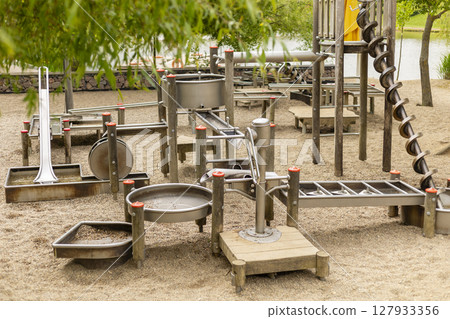 This engaging water play structure features various channels, slides, and water features designed for children's interactive play 127933356