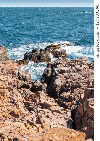 landscape of sea coast with rock in summer. wonderful weekend getaway in europe. textured coastline with blue sky above horizon 127933500