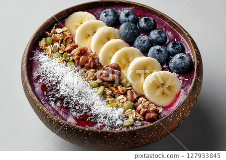 Colorful dish. Acai bowl with granola and edible flowers. Hotel Breakfast Styles. Colorful dish. Acai bowl with granola and edible flowers. Hotel Breakfast Styles. 127933845