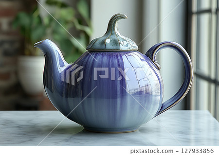 Ceramic teapot in shape of a purple eggplant in a rustic style on a white background. 127933856
