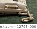 vintage phone with handset and answering machine on green velvet,the handset lies next. 127934000