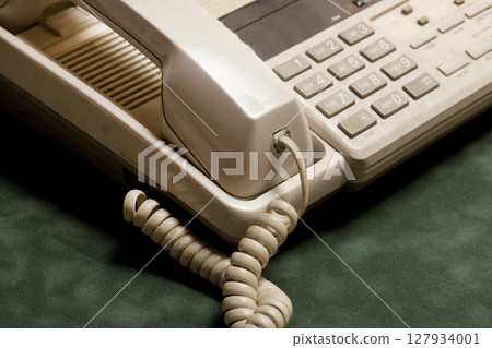 vintage phone with handset and answering machine on green velvet,the handset lies next. 127934001