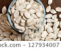 Large pumpkin seeds in a blue vase 127934007