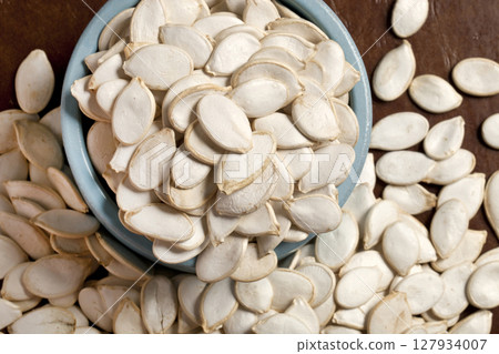 Large pumpkin seeds in a blue vase Large pumpkin seeds in a blue vase 127934007