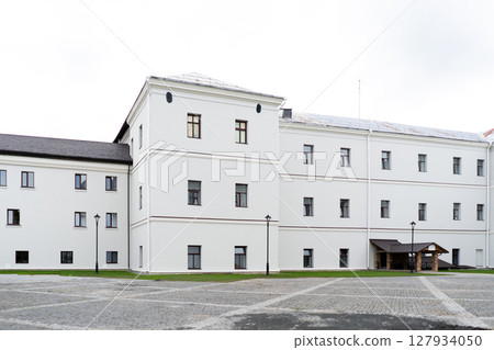 Modern building design house in concrete white with large windows and green lawn 127934050