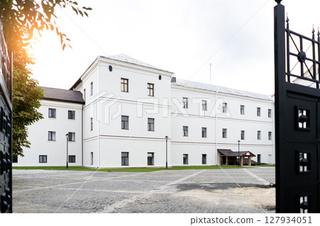 Modern building design house in concrete white with large windows and green lawn 127934051