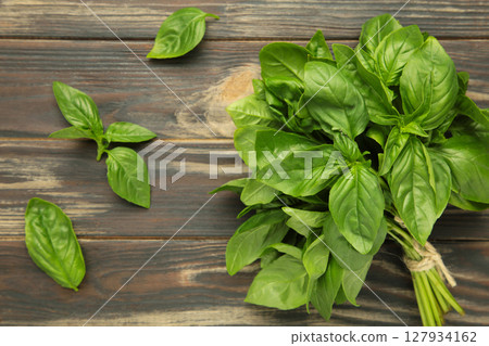 Green basil herb on brown background. Space for text Green basil herb on brown background. Space for text 127934162