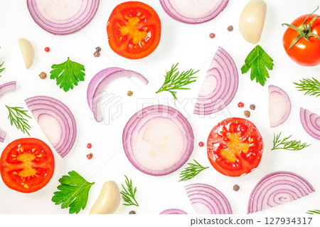Flat lay of sliced red onions, tomatoes, herbs, garlic and pepper on white background, ingredients for fresh salad or cooking 127934317