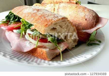 Close-up of baguette sandwich with italian martadella sausage 127934389