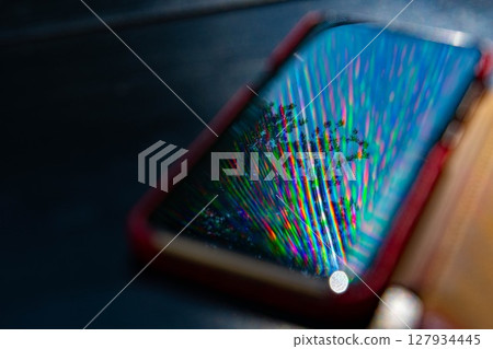 Spectrum blur reflection in glossy surface of smartphone 127934445