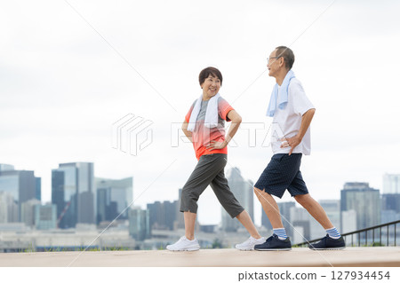 Senior men and women exercising 127934454
