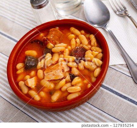 Tasty homemade stew of asturian beans with sausages. Spanish cuisine Tasty homemade stew of asturian beans with sausages. Spanish cuisine 127935254