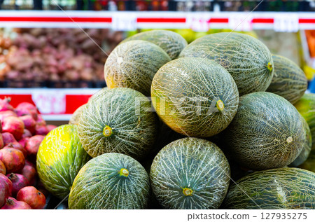 Melons on shelf in supermarket Melons on shelf in supermarket 127935275