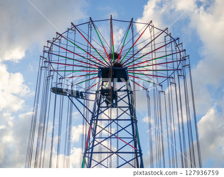 Amusement park. Entertainment concept. Carousel for children and adults. Thrilling sensations Amusement park. Entertainment concept. Carousel for children and adults. Thrilling sensations 127936759