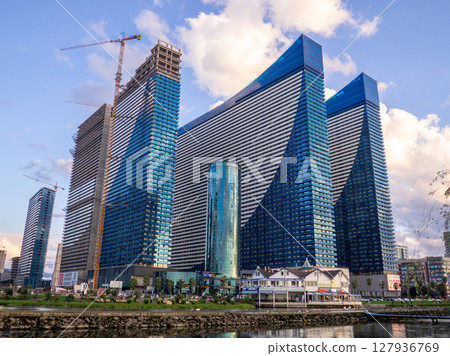 High-rise building under construction. Orbi city. Blue skyscraper. The tap is working. Completion of construction. Narrow high house. High-rise building under construction. Orbi city. Blue skyscraper. The tap is working. Completion of construction. Narrow high house. 127936769