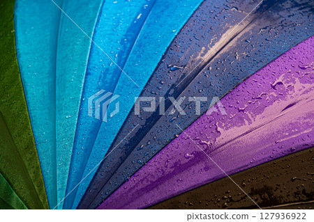 Raindrops on blue purple shades umbrella closeup wet fabric texture Raindrops on blue purple shades umbrella closeup wet fabric texture 127936922
