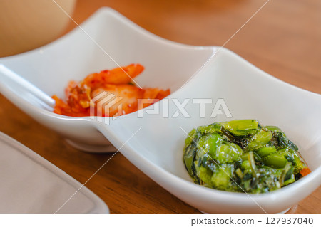 A small side dish of kimchi and boiled greens 127937040