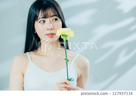 A young woman with flowers A young woman with flowers 127937116