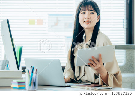 Young woman working with smile 127937150
