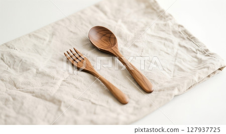 wooden spoon on white towel 127937725