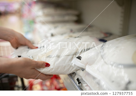 Shopper's hands buying rice Shopper's hands buying rice 127937755
