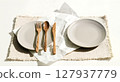knife and fork on linen napkin 127937779
