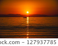 Sunset over the sea and small boats 127937785