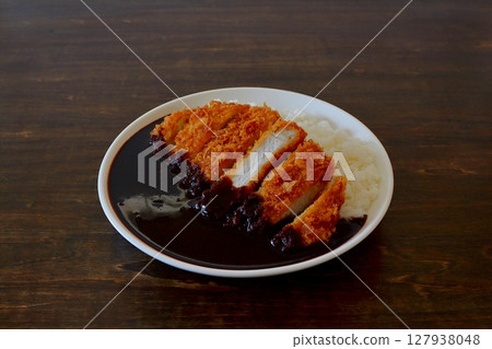 Katsu curry (black curry) on table background Katsu curry (black curry) on table background 127938048