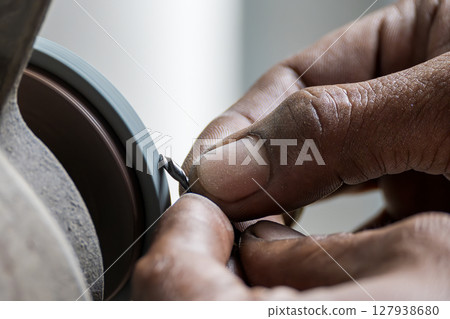 The small drill tool regrind process by manual operation with abrasive wheel. 127938680