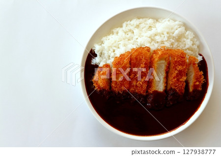 Katsu curry (black curry) seen from above on a white background Katsu curry (black curry) seen from above on a white background 127938777