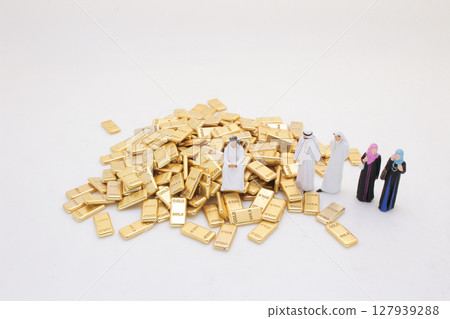 Group of Figurines Standing Beside a Pile of Gold Bars Group of Figurines Standing Beside a Pile of Gold Bars 127939288