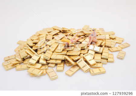 Figures on Pile of Gold Bars Depicting Wealth and Luxury Figures on Pile of Gold Bars Depicting Wealth and Luxury 127939296