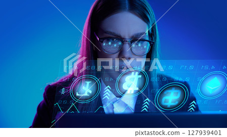 Focused professional analyzing cryptocurrency data on digital interface in futuristic setting 127939401
