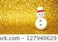 Snowman and golden snow scene 127940629