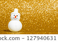 Snowman and golden snow scene 127940631