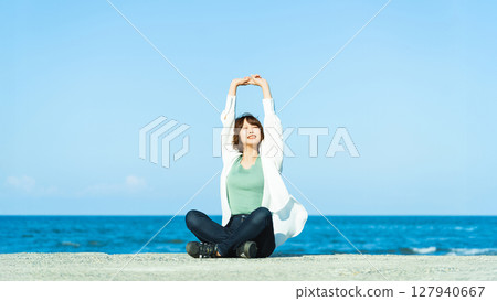 Woman relaxing at the beach in summer Woman relaxing at the beach in summer 127940667