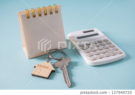 Home loan interest payment appointment. Calendar, house keys, calculator on the white table. 127940720