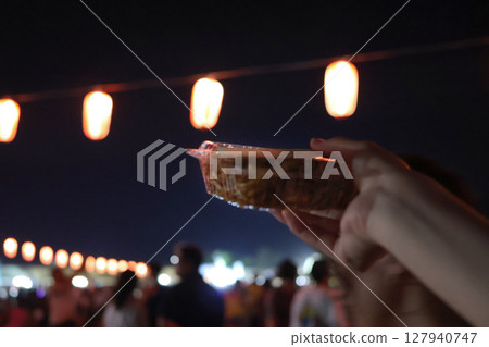 Fried noodles bought at a food stall with a lantern in the background Fried noodles bought at a food stall with a lantern in the background 127940747