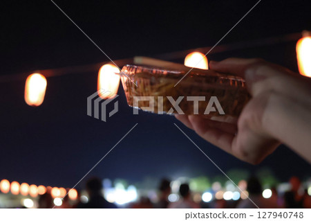 Fried noodles bought at a food stall with a lantern in the background Fried noodles bought at a food stall with a lantern in the background 127940748